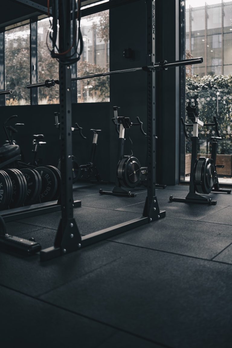 a gym with a row of exercise equipment